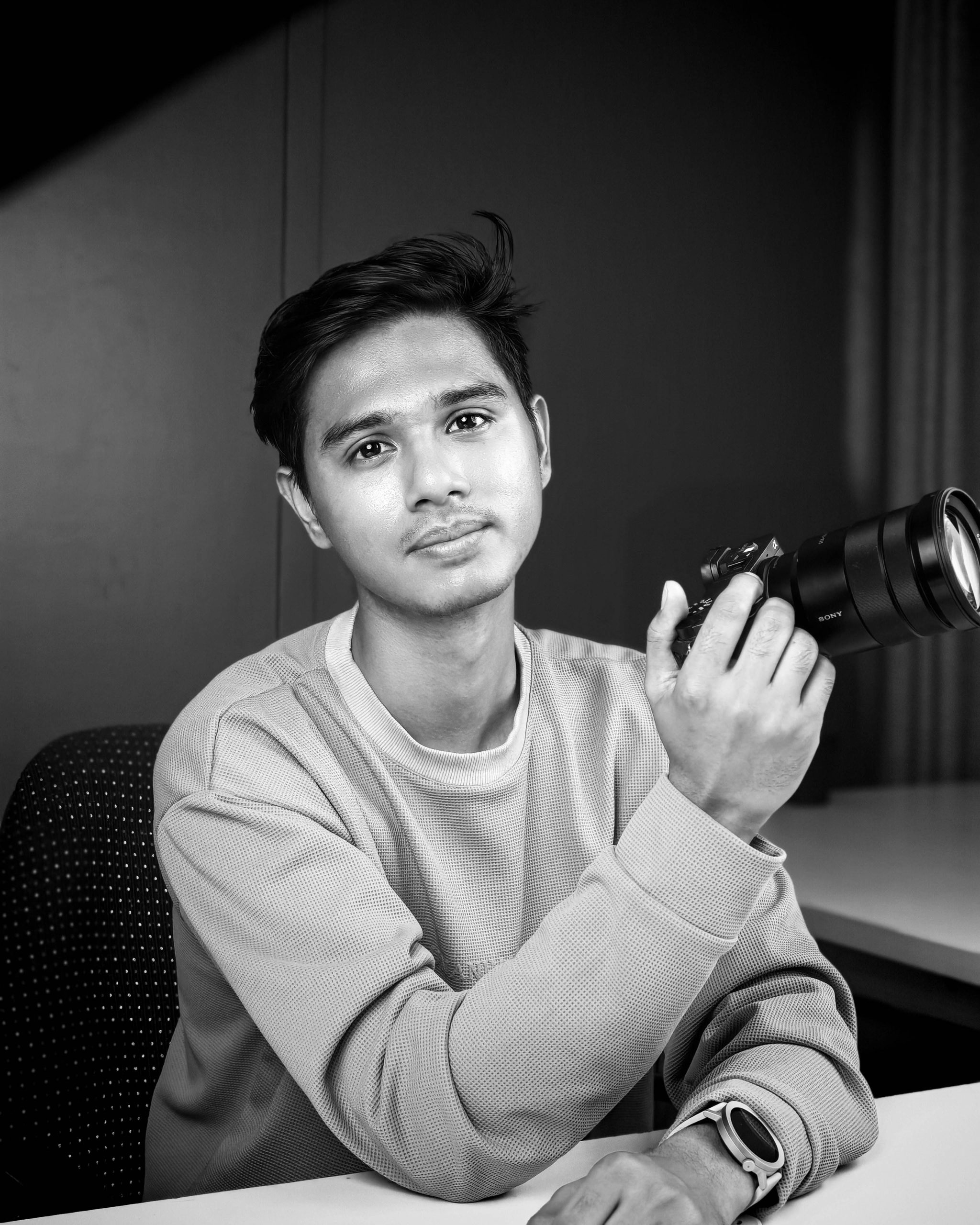 Pranish Khadgi holding a camera.